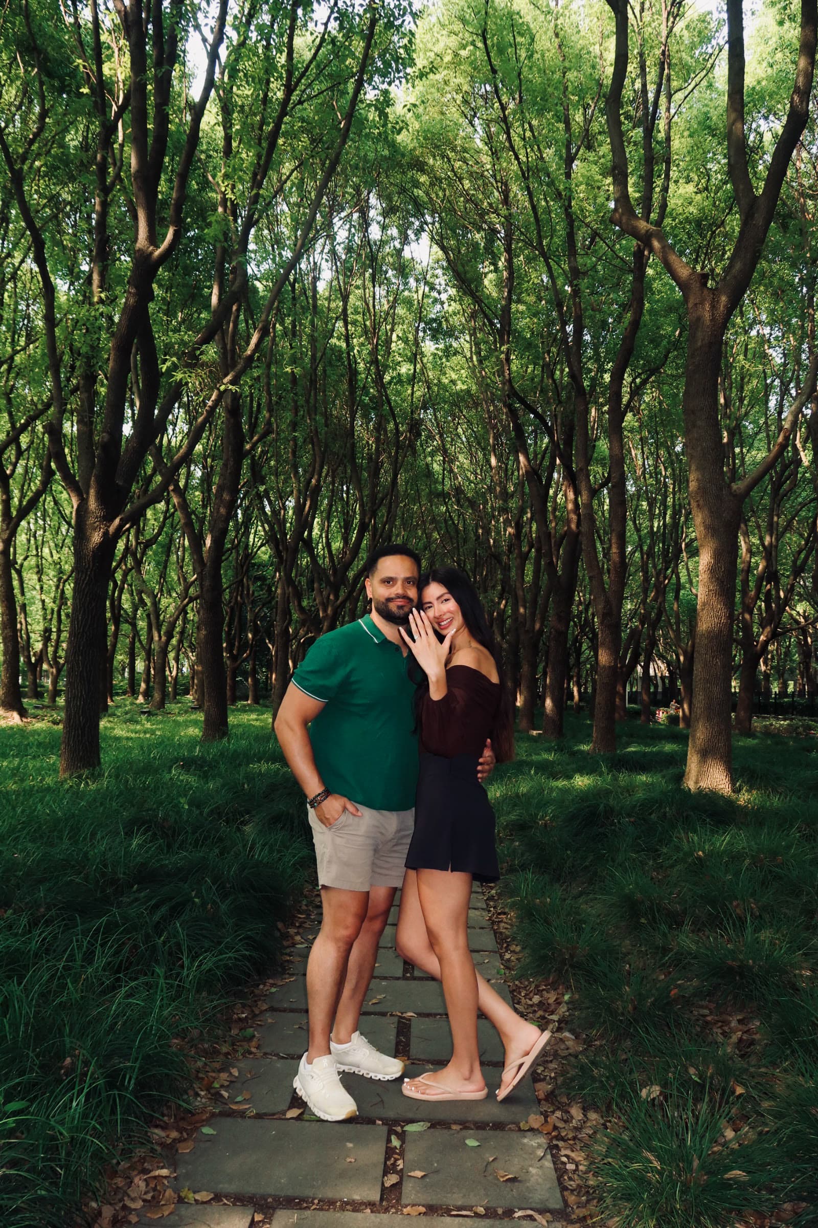 Danilo and Jotse celebrating their engagement in a wooded garden